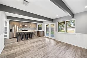 9638 Ravensworth Dr, Houston, TX 77031 - living room with french doors, beamed ceiling, and light wood finished floors