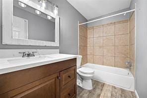 9638 Ravensworth Dr, Houston, TX 77031 - full bathroom with wood finished floors, toilet, vanity, and shower / bath combination