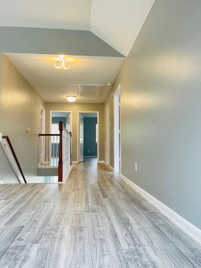 5530 Imperial Grove Dr, Houston, TX 77066 - hall with attic access, an upstairs landing, wood finished floors, baseboards, and vaulted ceiling