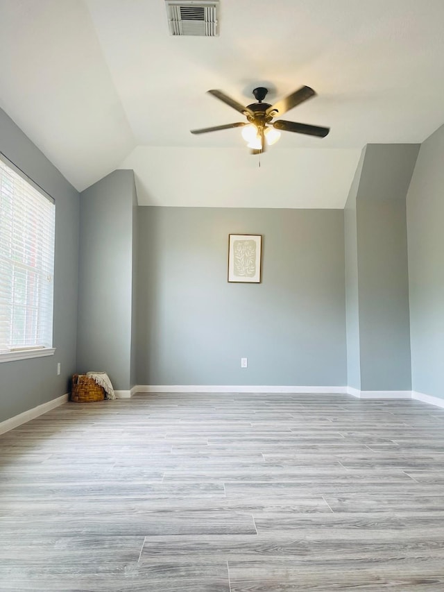 5530 Imperial Grove Dr, Houston, TX 77066 - empty room with a ceiling fan, wood finished floors, lofted ceiling, and baseboards