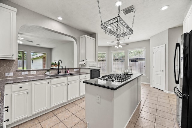 17518 Cypress Laurel St, Houston, TX 77095 - kitchen featuring ceiling fan, freestanding refrigerator, stainless steel gas cooktop, arched walkways, and recessed lighting