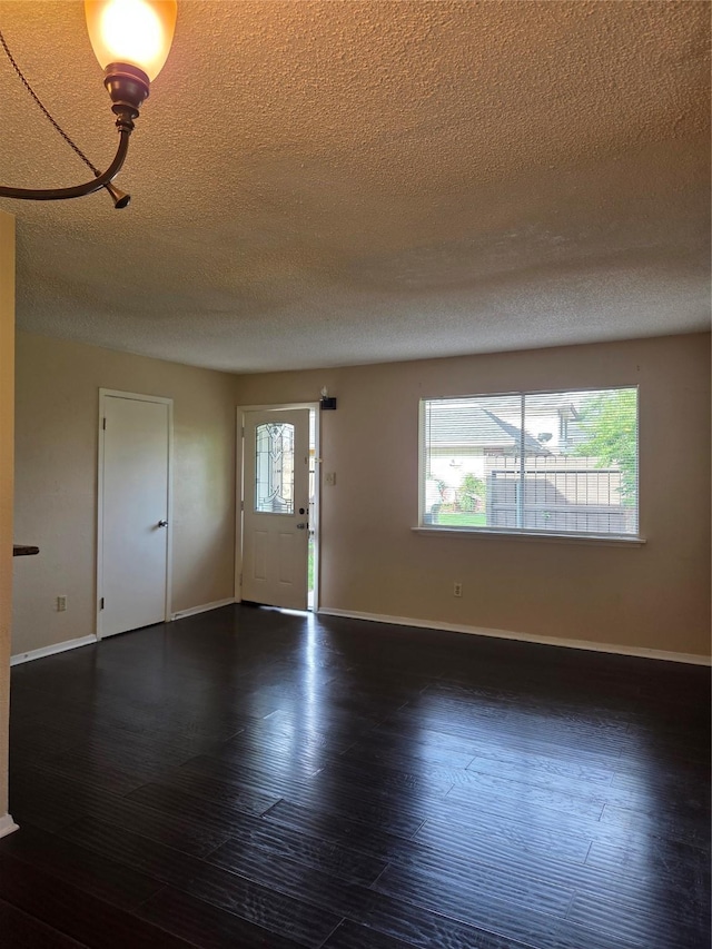 12029 Greenwood Forest Dr, Houston, TX 77066 - unfurnished room with a textured ceiling, baseboards, and wood finished floors