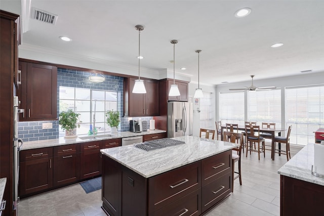 13210 Sycamore Heights St, Houston, TX 77065 - kitchen featuring appliances with stainless steel finishes, a sink, healthy amount of natural light, ceiling fan, and ornamental molding