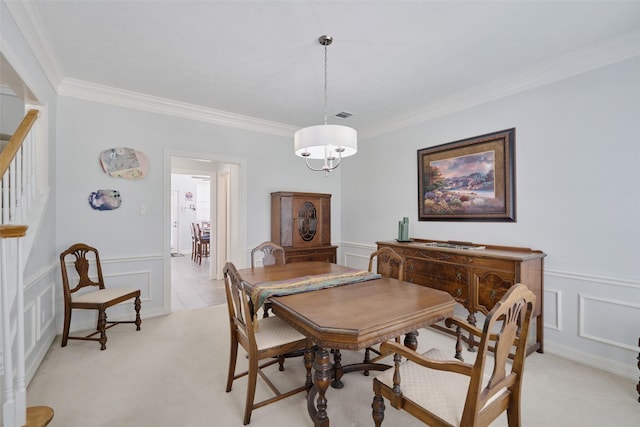 13210 Sycamore Heights St, Houston, TX 77065 - dining room featuring crown molding, a decorative wall, light colored carpet, wainscoting, and stairs