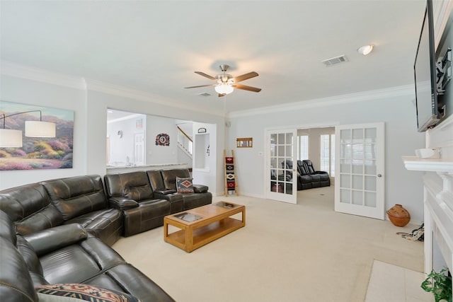 13210 Sycamore Heights St, Houston, TX 77065 - living room featuring french doors, stairway, a ceiling fan, crown molding, and carpet