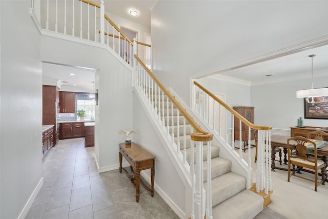 13210 Sycamore Heights St, Houston, TX 77065 - stairs featuring ornamental molding, a towering ceiling, and baseboards