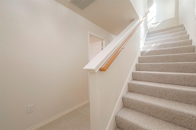 1119 Palmer St, Houston, TX 77003 - staircase with baseboards and tile patterned flooring
