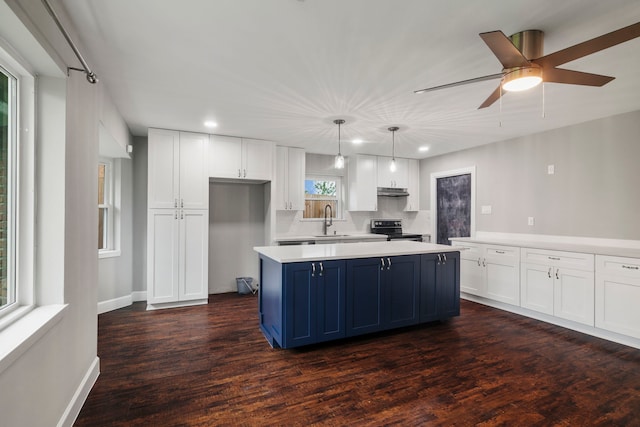 11215 Sageway Dr, Houston, TX 77089 - kitchen featuring electric stove, white cabinetry, blue cabinets, light countertops, and a center island