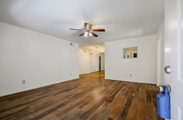 1311 Antoine Dr Unit 111, Houston, TX 77055 - empty room with dark wood finished floors, ceiling fan, a chandelier, and baseboards