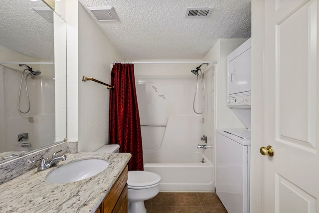1311 Antoine Dr Unit 111, Houston, TX 77055 - bathroom with stacked washing machine and dryer, a textured ceiling, shower / bathtub combination with curtain, toilet, and tile patterned floors