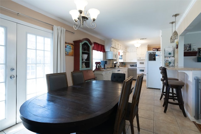 1803 Foxwood Rd, Houston, TX 77008 - dining space with a chandelier, healthy amount of natural light, ornamental molding, and light tile patterned floors