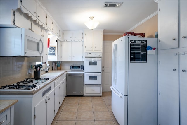 1803 Foxwood Rd, Houston, TX 77008 - kitchen featuring white appliances, tasteful backsplash, light countertops, crown molding, and light tile patterned floors
