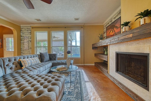 1114 Carriage Ct, Seabrook, TX 77586 - living area featuring arched walkways, light wood-type flooring, baseboards, a textured ceiling, and a ceiling fan