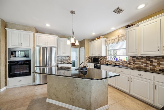 2 Slatestone Cir, The Woodlands, TX 77382 - kitchen featuring black appliances, a sink, decorative backsplash, white cabinetry, and recessed lighting