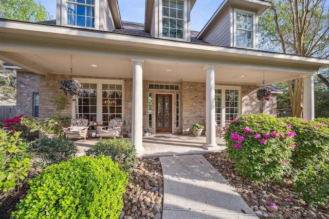 2 Slatestone Cir, The Woodlands, TX 77382 - view of exterior entry with brick siding and covered porch