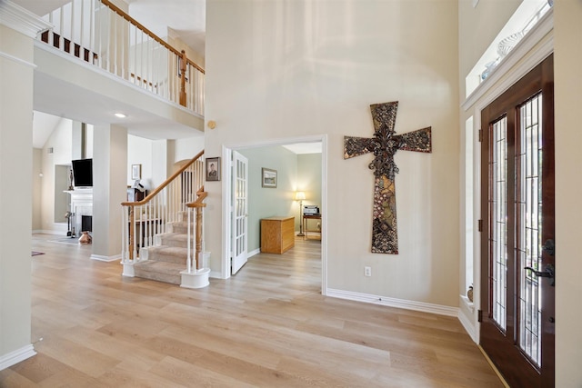 2 Slatestone Cir, The Woodlands, TX 77382 - entrance foyer featuring a high ceiling, french doors, stairway, wood finished floors, and baseboards