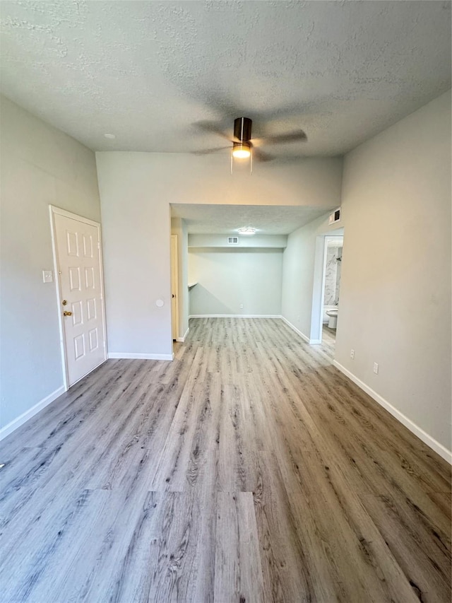 10555 Turtlewood Ct Unit 909, Houston, TX 77072 - spare room featuring wood finished floors, a textured ceiling, ceiling fan, and baseboards