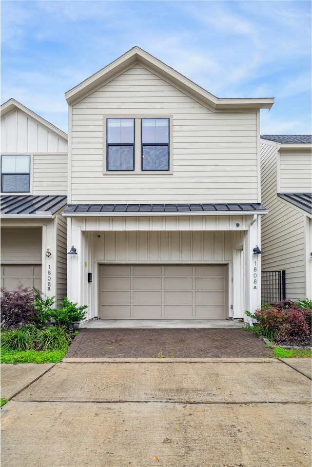 1808 Northwood St Unit A, Houston, TX 77009 - view of front of house with board and batten siding, a standing seam roof, driveway, and metal roof