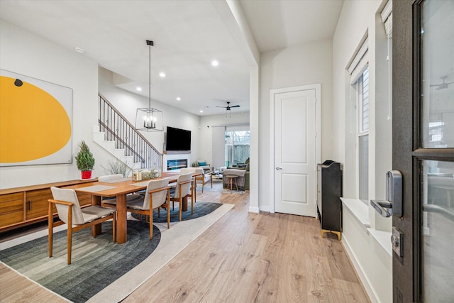 1808 Northwood St Unit A, Houston, TX 77009 - dining area with light wood finished floors, stairs, a glass covered fireplace, recessed lighting, and a ceiling fan