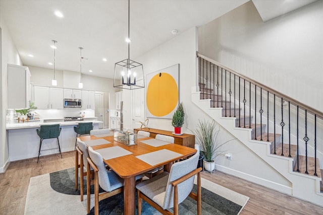 1808 Northwood St Unit A, Houston, TX 77009 - dining space featuring light wood finished floors, stairway, recessed lighting, baseboards, and a chandelier