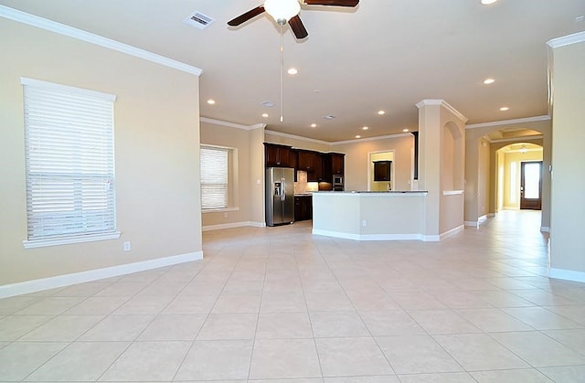 4435 Calvet Forest Dr, Katy, TX 77494 - unfurnished living room featuring ceiling fan, arched walkways, crown molding, recessed lighting, and light tile patterned floors