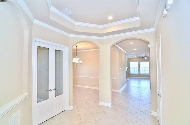 4435 Calvet Forest Dr, Katy, TX 77494 - hall featuring arched walkways, light tile patterned floors, french doors, ornamental molding, and a chandelier