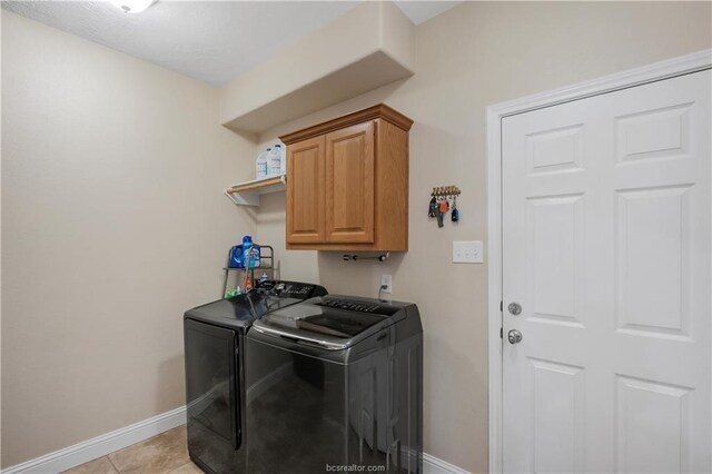 6443 Hardy Weedon Rd, College Station, TX 77845 - clothes washing area with independent washer and dryer, cabinet space, baseboards, and light tile patterned floors