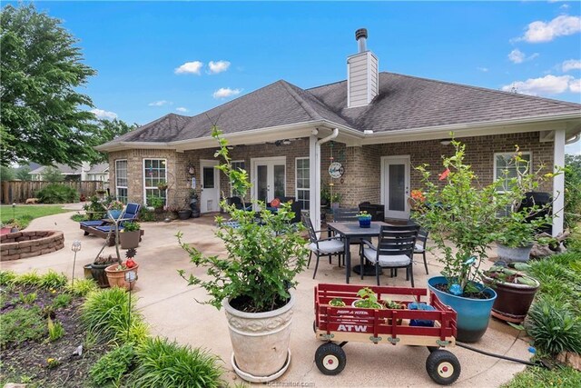 6443 Hardy Weedon Rd, College Station, TX 77845 - back of property with a patio, fence, a chimney, and roof with shingles