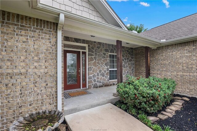 6443 Hardy Weedon Rd, College Station, TX 77845 - doorway to property with brick siding, roof with shingles, and stone siding