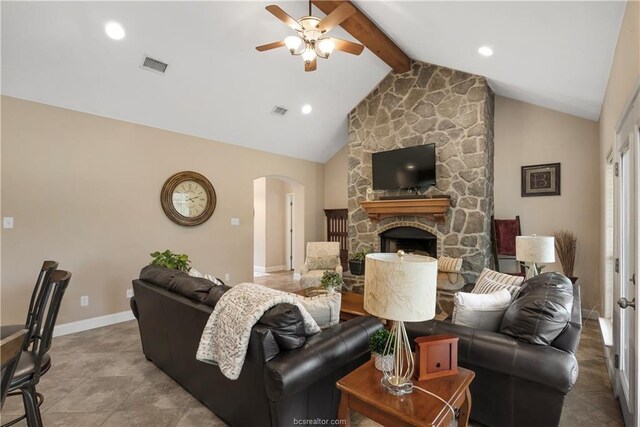 6443 Hardy Weedon Rd, College Station, TX 77845 - living room with a ceiling fan, arched walkways, a fireplace, baseboards, and tile patterned flooring