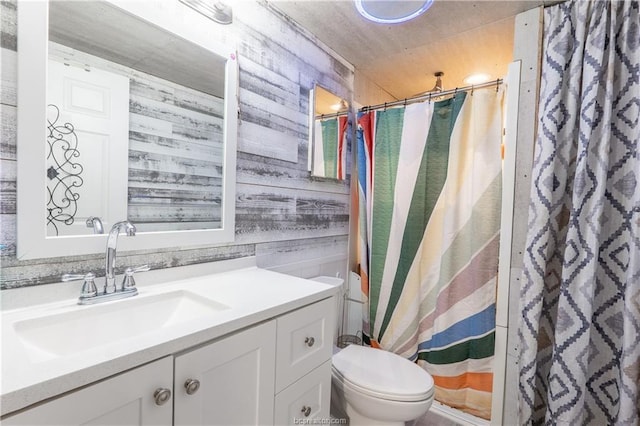 6443 Hardy Weedon Rd, College Station, TX 77845 - full bathroom with wood walls, vanity, toilet, and a shower with curtain