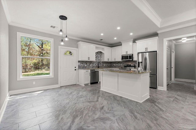 247 Mistletoe, Onalaska, TX 77360 - kitchen with appliances with stainless steel finishes, light marble finish floors, ornamental molding, baseboards, and tasteful backsplash