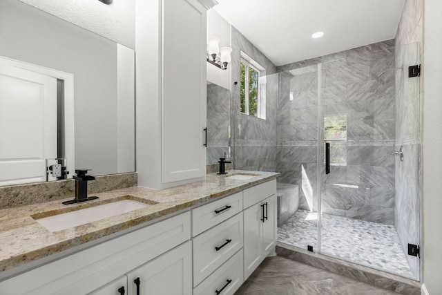 247 Mistletoe, Onalaska, TX 77360 - full bathroom with a stall shower, double vanity, and marble look tiles