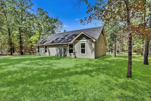 247 Mistletoe, Onalaska, TX 77360 - view of front of house featuring roof with shingles and a front lawn