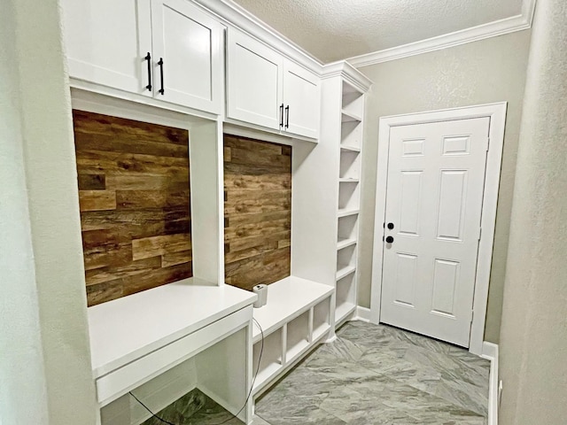 247 Mistletoe, Onalaska, TX 77360 - mudroom with crown molding, light marble finish flooring, a textured ceiling, and wooden walls
