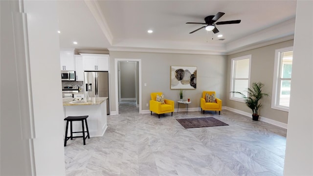 247 Mistletoe, Onalaska, TX 77360 - living area featuring ornamental molding, a ceiling fan, recessed lighting, baseboards, and a tray ceiling