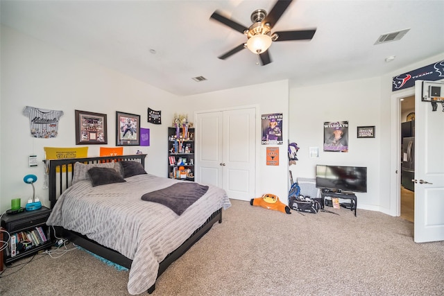 11434 Ketch Ct, Willis, TX 77318 - carpeted bedroom with a closet, a ceiling fan, stainless steel refrigerator with ice dispenser, and baseboards