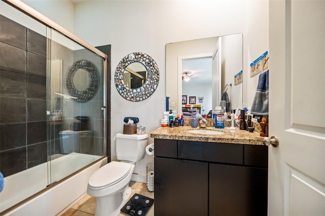 11434 Ketch Ct, Willis, TX 77318 - bathroom with toilet, vanity, tile patterned floors, a ceiling fan, and bath / shower combo with glass door