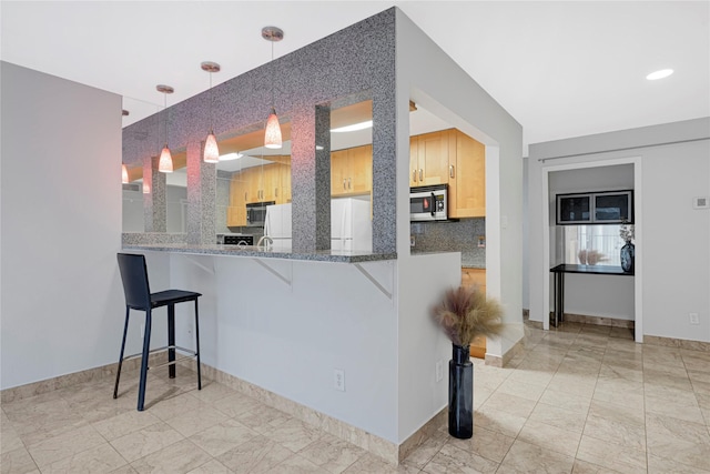 2333 Bering Dr Unit 124, Houston, TX 77057 - kitchen featuring stainless steel microwave, a breakfast bar, tasteful backsplash, and hanging light fixtures