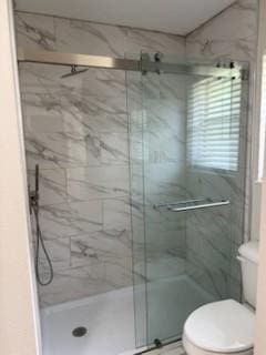 8615 Washington Blvd, Beaumont, TX 77707 - bathroom featuring toilet and a marble finish shower