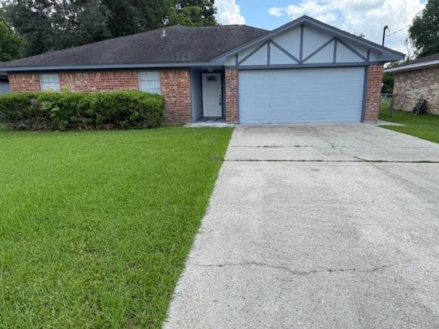 8615 Washington Blvd, Beaumont, TX 77707 - view of front of house with brick siding, a front lawn, concrete driveway, and an attached garage