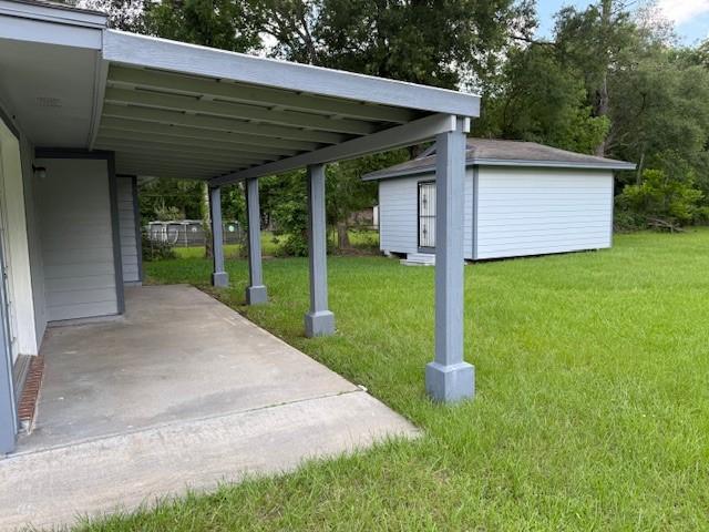 8615 Washington Blvd, Beaumont, TX 77707 - view of parking with a carport