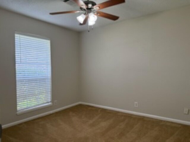 8615 Washington Blvd, Beaumont, TX 77707 - unfurnished room with carpet, baseboards, and a ceiling fan