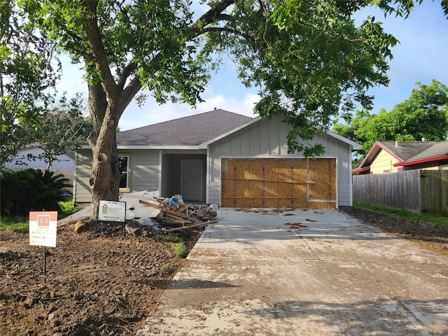 1617 14th Ave N, Texas City, TX 77590 - view of front of home with fence, a garage, driveway, and a shingled roof