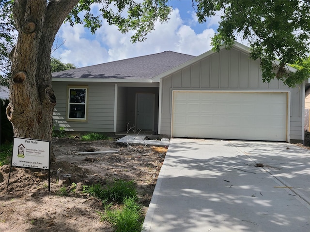 1617 14th Ave N, Texas City, TX 77590 - ranch-style home with an attached garage, concrete driveway, board and batten siding, and roof with shingles