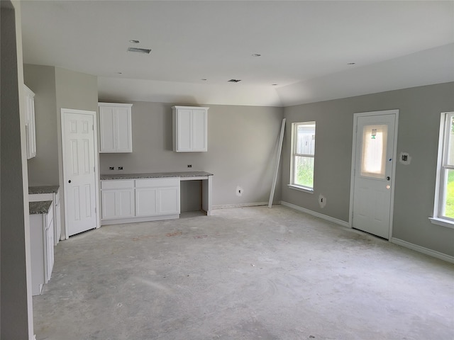 1617 14th Ave N, Texas City, TX 77590 - kitchen featuring concrete floors and white cabinets