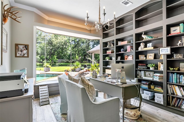 11 Turtle Cove Ct, Kingwood, TX 77346 - office area featuring crown molding, a chandelier, light wood finished floors, and built in features