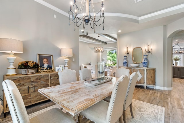 11 Turtle Cove Ct, Kingwood, TX 77346 - dining room featuring arched walkways, crown molding, a chandelier, wood finished floors, and baseboards