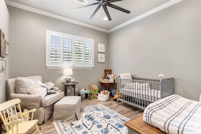 11 Turtle Cove Ct, Kingwood, TX 77346 - bedroom with crown molding, wood finished floors, recessed lighting, a nursery area, and ceiling fan