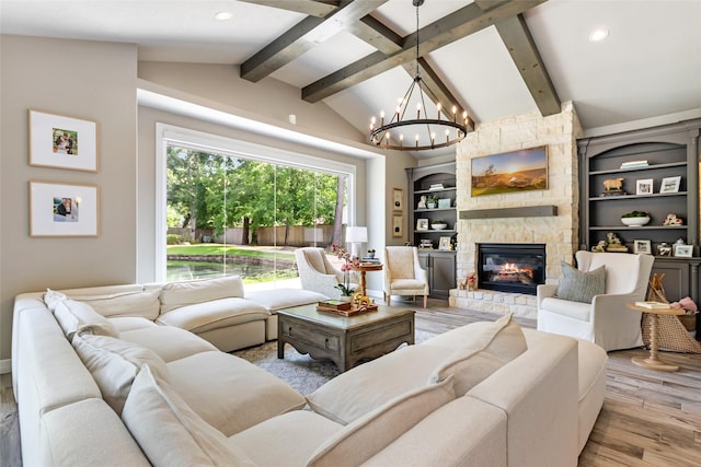 11 Turtle Cove Ct, Kingwood, TX 77346 - living area with wood finished floors, a chandelier, a stone fireplace, recessed lighting, and baseboards